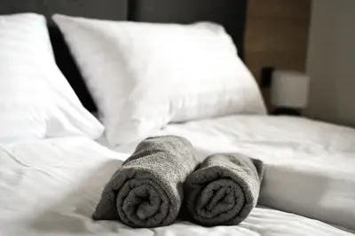 a pair of towels sitting on top of a bed at Pensjonat Zdrojowy Apartamenty in Rabka