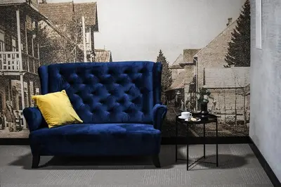 a blue chair with a yellow pillow in a room at Pensjonat Zdrojowy Apartamenty in Rabka