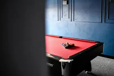a red pool table with a toy on it at Pensjonat Zdrojowy Apartamenty in Rabka