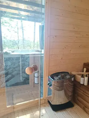 a sauna with a shower and a hot tub at Mucharskie Stodoły Stodoła I - Garden Spa in Jaszczurowa