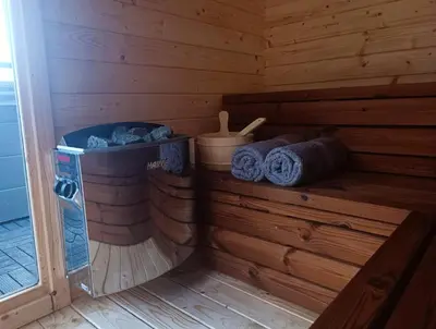 a sauna with blue towels in a wooden cabin at Mucharskie Stodoły Stodoła I - Garden Spa in Jaszczurowa