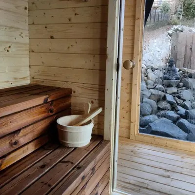 a wooden tub in a sauna with a window at Mucharskie Stodoły Stodoła I - Garden Spa in Jaszczurowa