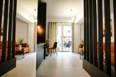 two views of a living room and a dining room at ApartPark Centrum Zator Bronze in Zator