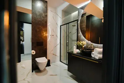 a bathroom with a toilet and a sink and a mirror at ApartPark Centrum Zator Bronze in Zator