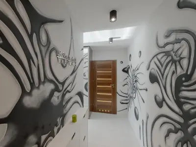 a hallway with a wall with a painting on it at atHome in Kraków