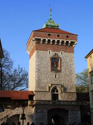 a tall tower with a clock on top of it at atHome in Kraków