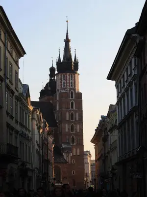 a tall building with a clock tower on a city street at atHome in Kraków
