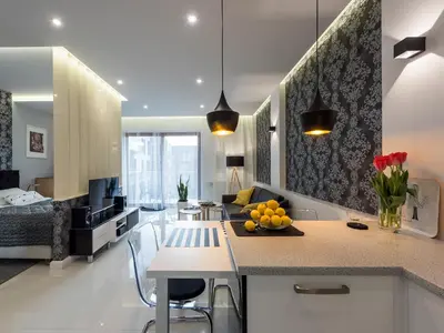 a kitchen and living room with a table with fruit on it at Black Pearl Apartment in Kraków