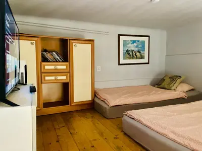 a small bedroom with two beds and a tv at Sebastiana Studio Old Town in Kraków