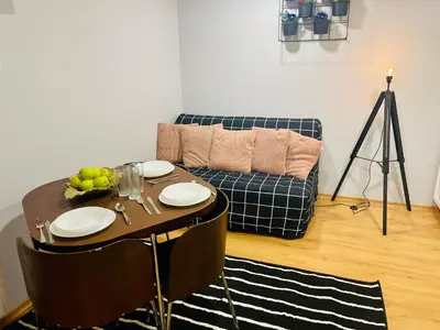 a living room with a table and a couch at Sebastiana Studio Old Town in Kraków
