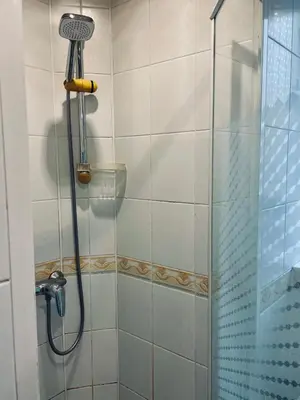 a shower in a bathroom with a glass door at Sebastiana Studio Old Town in Kraków