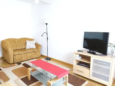 a living room with a couch and a television at Kazimierza Wielkiego 84 by Homeprime in Kraków