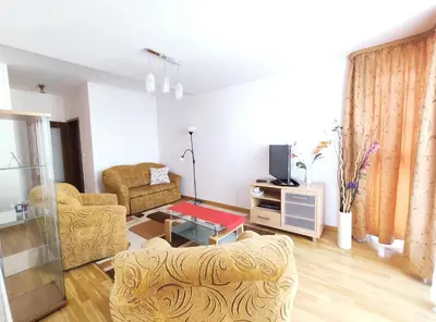 a living room with two chairs and a tv at Kazimierza Wielkiego 84 by Homeprime in Kraków