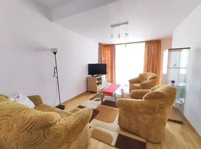 a living room with two chairs and a television at Kazimierza Wielkiego 84 by Homeprime in Kraków