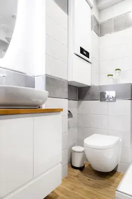 a white bathroom with a sink and a toilet at Househost Apartment:Bracka 3/15A in Kraków