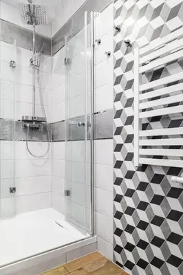 a bathroom with a shower with a glass door at Househost Apartment:Bracka 3/15A in Kraków