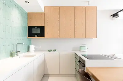 a kitchen with white cabinets and a sink at Premium Designer Apartment - Quiet and Central in Kraków