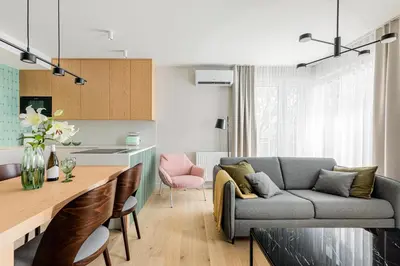 a kitchen and living room with a couch and a table at Premium Designer Apartment - Quiet and Central in Kraków