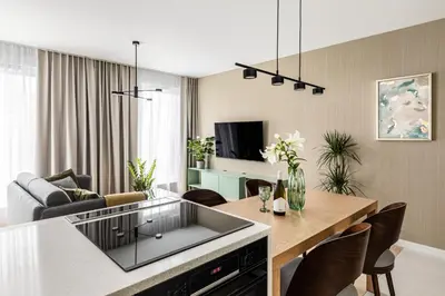 a kitchen and living room with a table and chairs at Premium Designer Apartment - Quiet and Central in Kraków