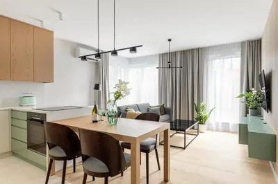 a kitchen and dining room with a table and chairs at Premium Designer Apartment - Quiet and Central in Kraków