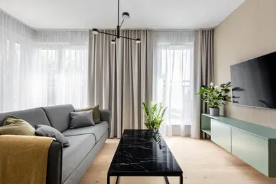 a living room with a couch and a tv at Premium Designer Apartment - Quiet and Central in Kraków