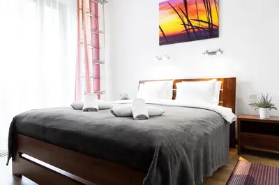 a bedroom with a large bed with two pillows on it at HOUSEHOST Apartment:Lubicz 17D/5 in Kraków