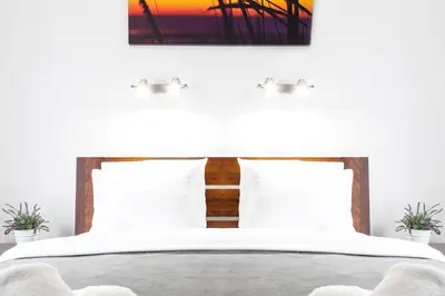 a bedroom with a bed with white sheets and pillows at HOUSEHOST Apartment:Lubicz 17D/5 in Kraków