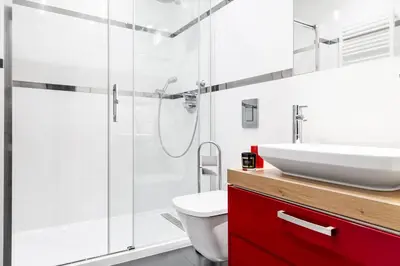 a bathroom with a sink and a shower at HOUSEHOST Apartment:Lubicz 17D/5 in Kraków