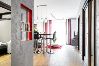 a living room with a table and chairs at HOUSEHOST Apartment:Lubicz 17D/5 in Kraków
