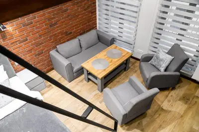 a living room with a couch and two chairs and a table at HOUSEHOST Apartment:Bracka 3/15B in Kraków