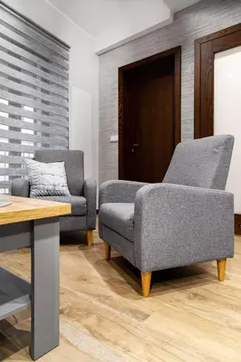 a living room with two chairs and a table at HOUSEHOST Apartment:Bracka 3/15B in Kraków