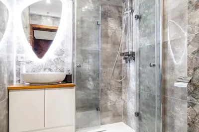a bathroom with a sink and a shower at HOUSEHOST Apartment:Bracka 3/15B in Kraków