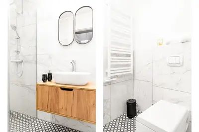 a bathroom with a sink and a mirror at HOUSEHOST Apartment: Św.Gertrudy 10/0.2 in Kraków