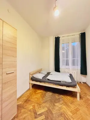 a bedroom with a bed in front of a window at Main Square Rooms in Kraków