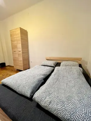 two beds sitting next to each other in a bedroom at Main Square Rooms in Kraków