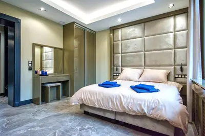 a bedroom with a large bed with blue towels on it at Sienkiewiczówka in Rabka