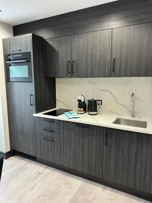 a kitchen with wooden cabinets and a sink and a counter at Sienkiewiczówka in Rabka