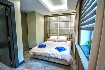 a bedroom with a bed with blue towels on it at Sienkiewiczówka in Rabka