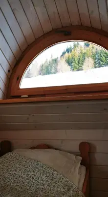 a window in a room with a bed in it at Sarni Szlak in Zawoja