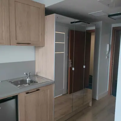 a kitchen with a sink and a hallway with a door at Sympozjum Loft in Kraków
