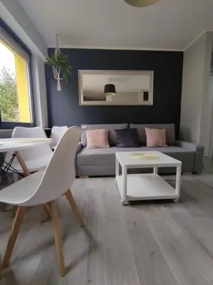 a living room with a couch and a table at Przytulne mieszkanko in Oświęcim