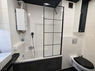 a bathroom with a shower and a toilet and a sink at Przytulne mieszkanko in Oświęcim