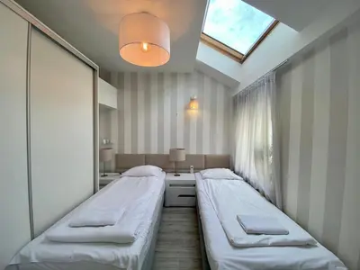 a hospital room with two beds and a window at Garbarska LUX with Air Condition in Kraków