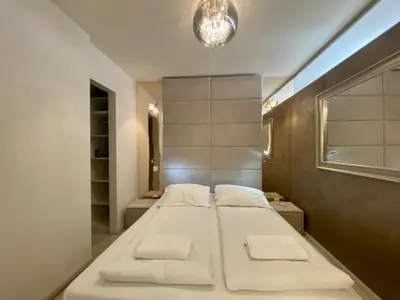 a bedroom with four beds in a room with a window at Garbarska LUX with Air Condition in Kraków
