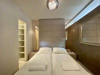 a bedroom with a large bed with two pillows at Garbarska LUX with Air Condition in Kraków