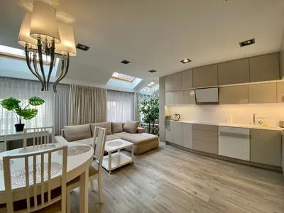 a kitchen and living room with a couch and a table at Garbarska LUX with Air Condition in Kraków