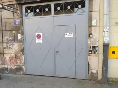 two doors on the side of a building with graffiti at Garbarska LUX with Air Condition in Kraków