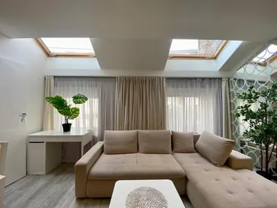 a living room with a couch and a window at Garbarska LUX with Air Condition in Kraków