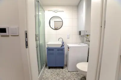 a bathroom with a toilet and a sink and a mirror at CracWoW Saint Sebastian Apartments in Kraków