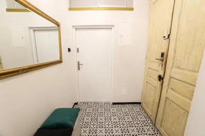 a room with a mirror and a door at CracWoW Saint Sebastian Apartments in Kraków